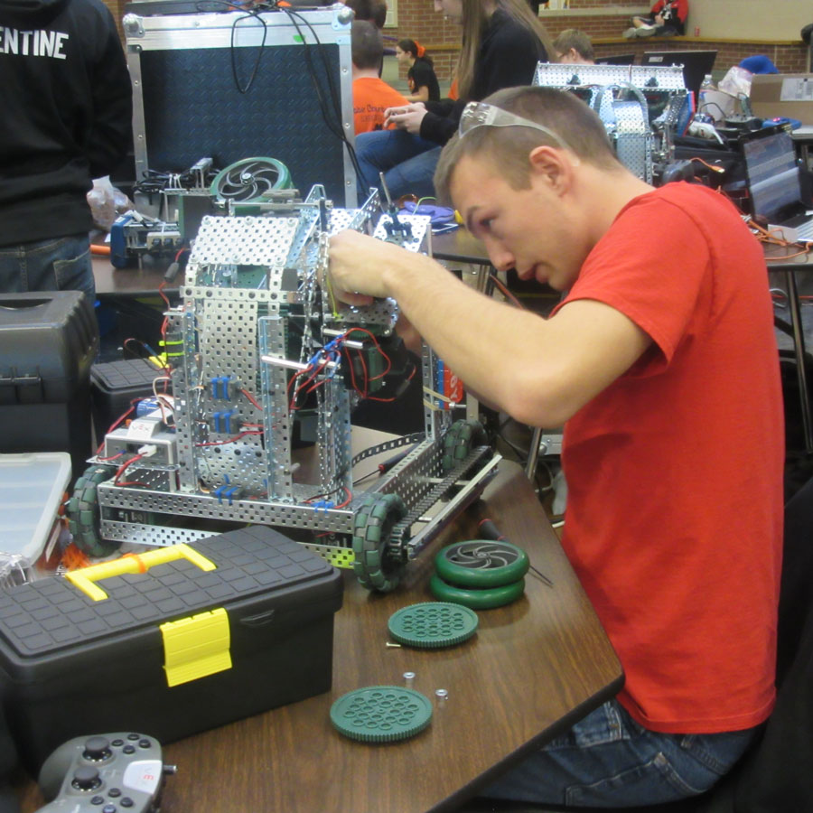 Jeremy Schaffer works on his team's robot