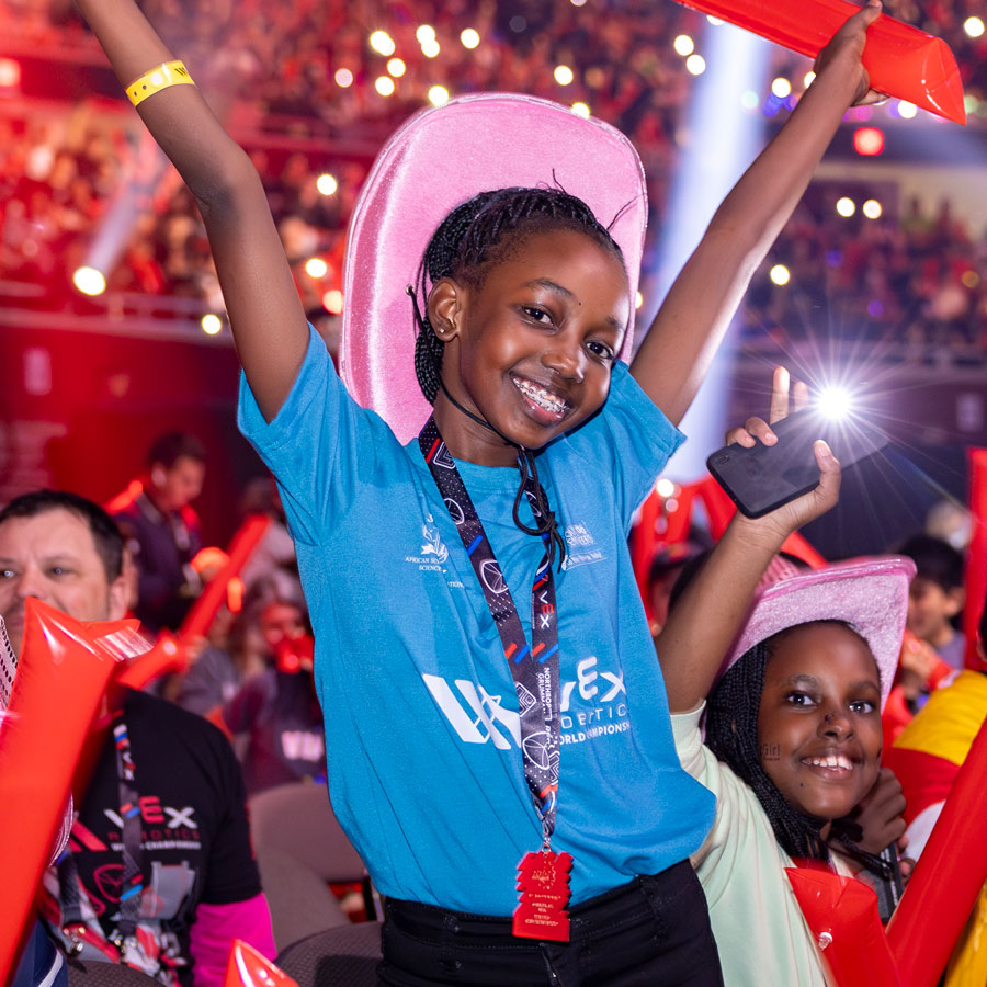 Participant stands among the crowd in the dome at VEX Robotics World Championship