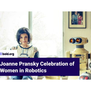 Joanne Pransky sits next to a robot.