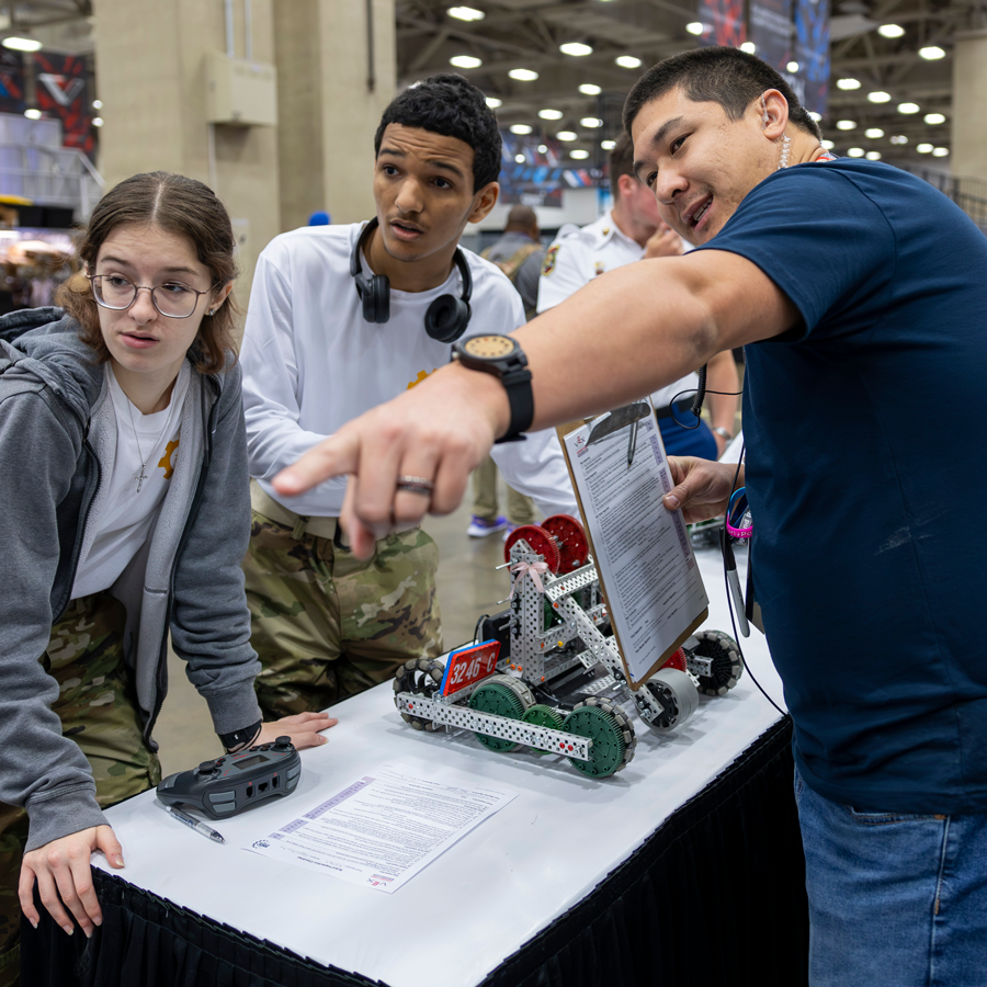 Inspector assists a team at VEX Robotics World Championship