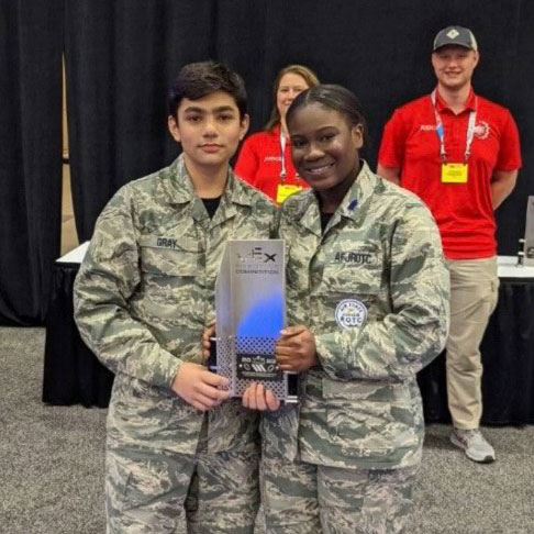 Ifeoluwa Ogunfolu and teammate hold award atevent