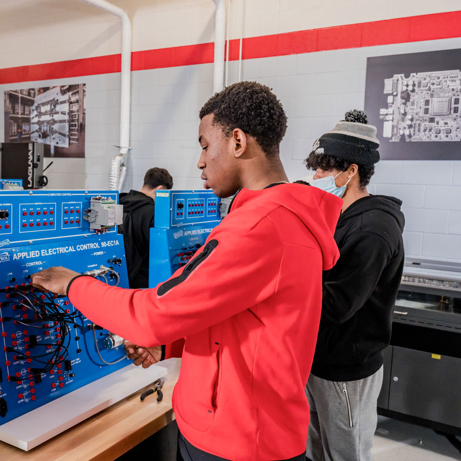 Students work on machine
