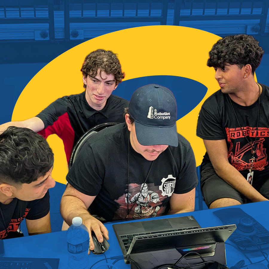 Team gathered around a laptop