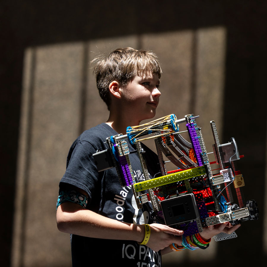Student carries his robot at the VEX Robotics World Championship