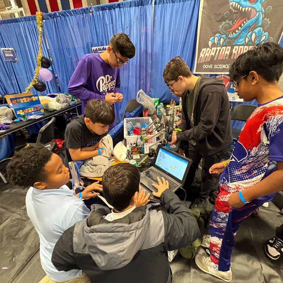 Team works on robot in pit