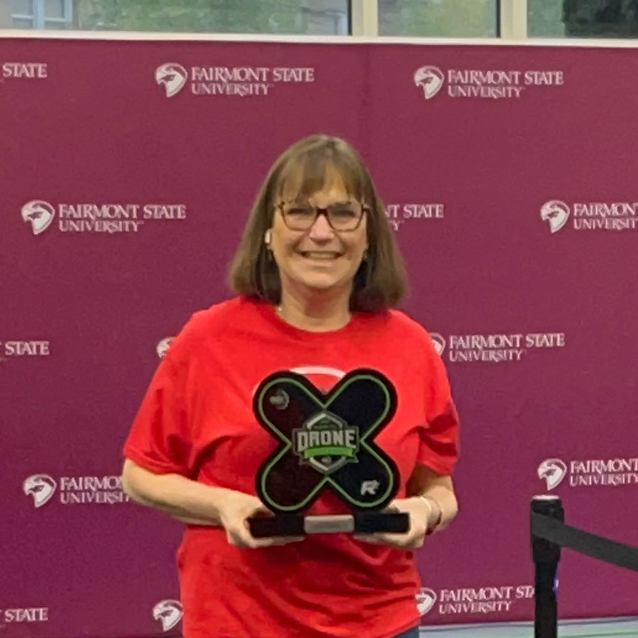 Cindy Watson with a robotics trophy